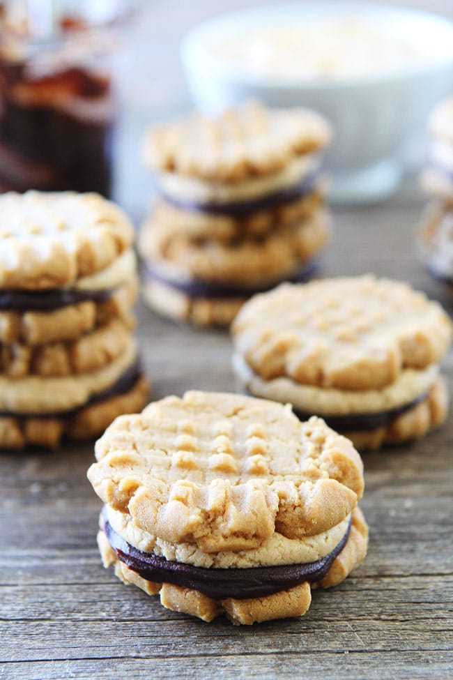 Flourless Peanut Butter Chocolate Ganache Sandwich Cookies Recipe on twopeasandtheirpod.com The BEST peanut butter cookies and they are gluten-free too! Flourless Peanut Butter Chocolate Ganache Sandwich Cookies Recipe