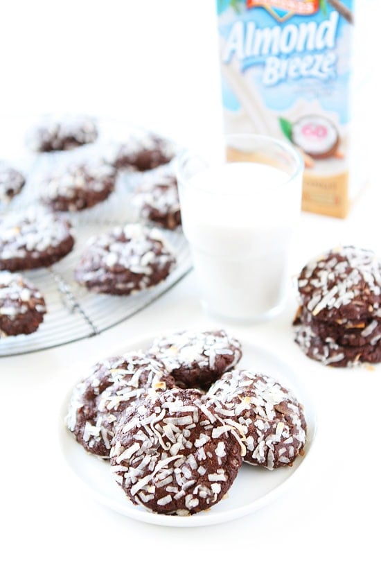 Vegan Chocolate Coconut Cookie Recipe on twopeasandtheirpod.com Rich, fudgy, and rolled in coconut! We love these cookies! Chocolate Coconut Cookies made with Almond Breeze Coconut Milk