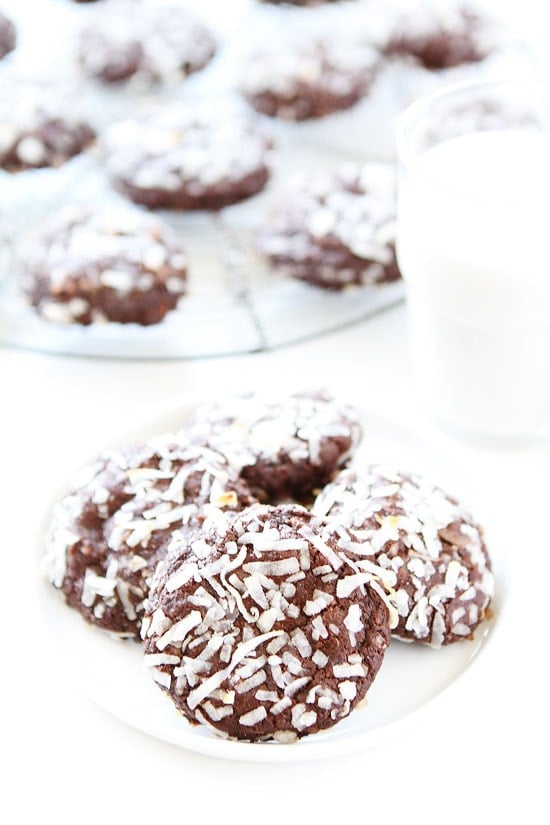 Vegan Chocolate Coconut Cookie Recipe on twopeasandtheirpod.com These vegan cookies are SO good! The chocolate and coconut combo is amazing! Vegan Chocolate Coconut Cookies ready to eat on plate served with coconut milk