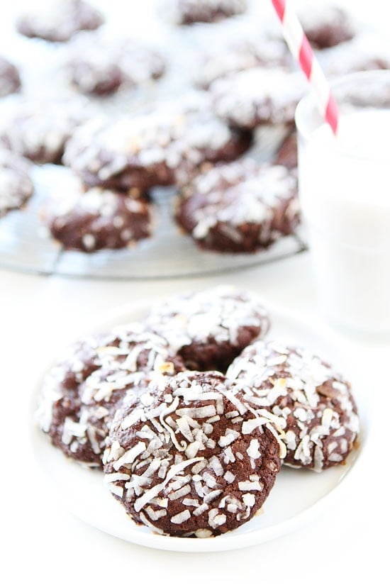 Vegan Chocolate Coconut Cookie Recipe on twopeasandtheirpod.com Rich, fudgy, and rolled in coconut! These chocolate cookies are divine! Vegan Chocolate Coconut Cookies on plate with a glass of milk