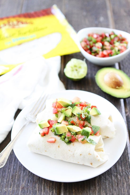 Chorizo Bacon Breakfast Burrito Recipe on twopeasandtheirpod.com Breakfast burritos with chorizo, bacon, eggs, potatoes, and cheese! The ultimate breakfast burritos! Breakfast Burrito with Chorizo and Bacon topped with avocado