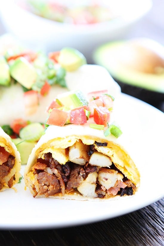 Chorizo Bacon Breakfast Burrito Recipe on twopeasandtheirpod.com Breakfast burritos with chorizo, bacon, eggs, potatoes, and cheese! The burritos freeze well too! Breakfast Burrito loaded with potatoes bacon and chorizo