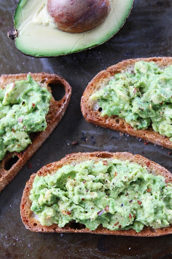 Garlic Bread Avocado Toasts Recipe on twopeasandtheirpod.com Buttery garlic bread with mashed avocado, this garlic bread is amazing! How to make Avocado Toast with garlic bread