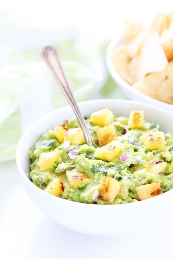 Grilled Pineapple Guacamole Recipe on twopeasandtheirpod.com The ultimate guacamole for summertime! Serve it at all of your summer BBQ's! Grilled Pineapple Guacamole Recipe