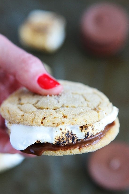 Peanut Butter Cookie S'mores Recipe on twopeasandtheirpod.com Peanut butter cookies, peanut butter cups, and marshmallows make the ULTIMATE s'mores! The perfect treat for summertime! Peanut Butter Cookie S'mores Recipe