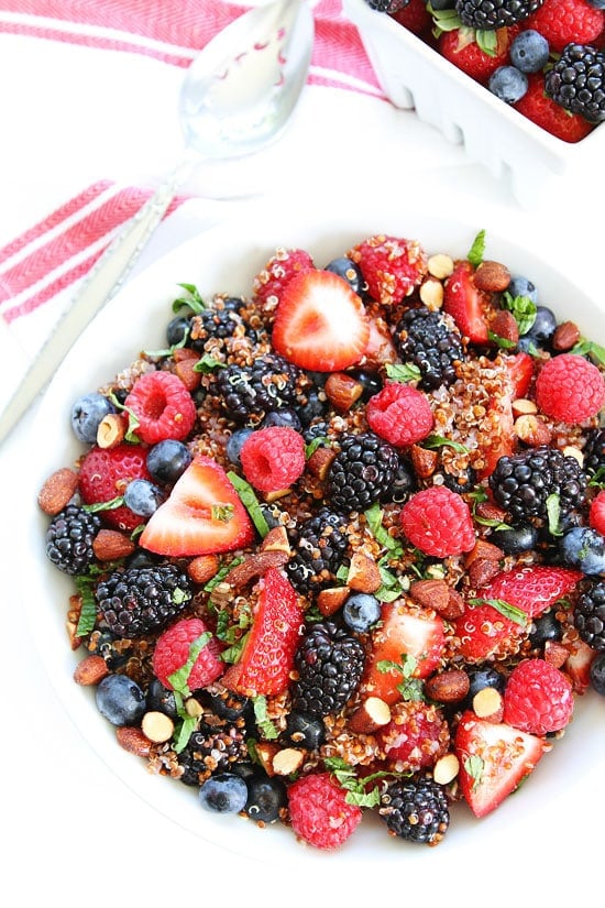 Berry Quinoa Salad Recipe on twopeasandtheirpod.com This easy and healthy fruit salad is great for breakfast, snack time, or served as a side dish! Berry Quinoa Salad in bowl with blackberries, raspberries, and blueberries.