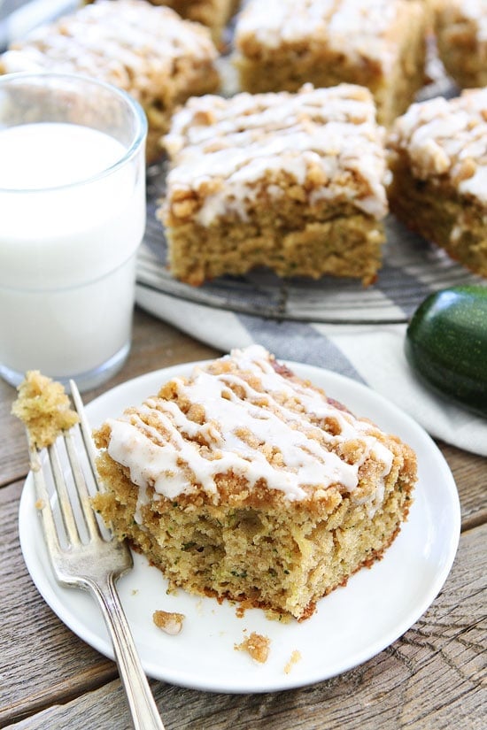 Brown Butter Zucchini Coffee Cake Recipe on twopeasandtheirpod.com Trying to use up your summer zucchini? Make this easy and delicious cake! Everyone will be begging for the recipe and another piece! Brown Butter Zucchini Coffee Cake on plate with glass of milk