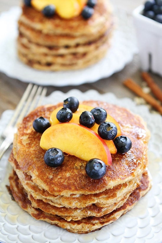 Cinnamon Oatmeal Pancakes Recipe on twopeasandtheirpod.com These healthy and hearty pancakes are a favorite at our breakfast table! The batter can be made in advance and the pancakes freeze well too! Oatmeal Pancakes with Cinnamon topped with blueberries