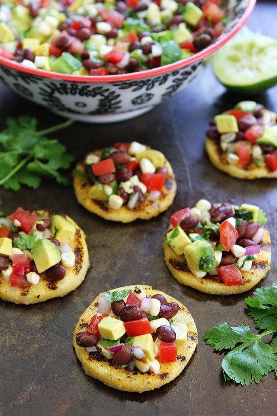 Grilled Polenta Rounds with Black Bean and Avocado Salsa Recipe on twopeasandtheirpod.com This easy appetizer is always a hit at parties! Grilled Polenta Rounds with Black Bean and Avocado Salsa Recipe