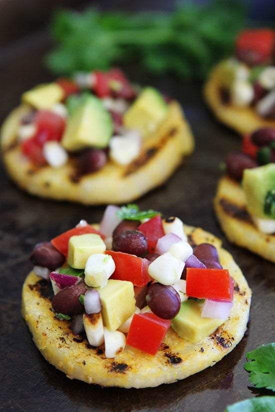 Grilled Polenta Rounds with Black Bean and Avocado Salsa Recipe on twopeasandtheirpod.com This easy summer appetizer is perfect for entertaining! Grilled Polenta Rounds with Black Bean and Avocado Salsa Recipe