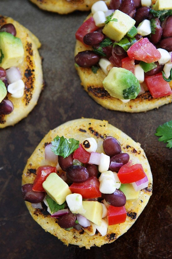 Grilled Polenta Rounds with Black Bean and Avocado Salsa Recipe on twopeasandtheirpod.com This simple and healthy appetizer is always a favorite at parties! Grilled Polenta Rounds with Black Bean and Avocado Salsa Recipe