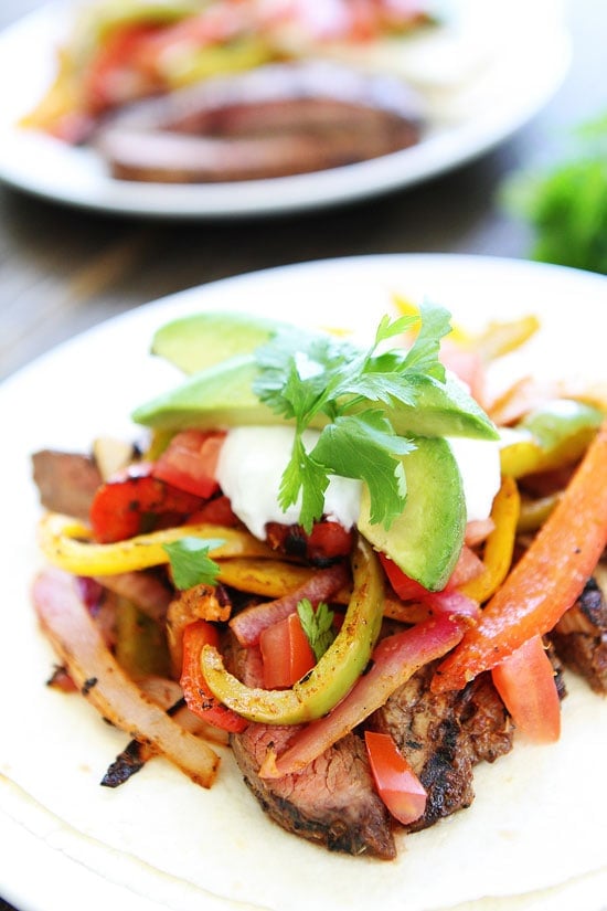 Grilled Steak Fajitas Recipe on twopeasandtheirpod.com A great summer dinner! Closeup of Steak Fajitas ready to eat