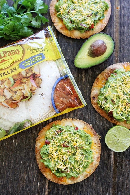 Cheesy Guacamole Tostadas Recipe on twopeasandtheirpod.com These easy and cheesy tostadas only take 20 minutes to make! How to make Tostadas with Store-Bought Tortillas