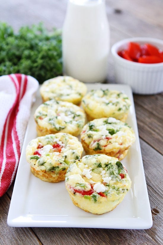 Egg Muffins with Kale, Roasted Red Peppers, and Feta Cheese Recipe on twopeasandtheirpod.com These easy egg muffins are perfect for a healthy breakfast on the go! They freeze well too! Egg Muffins with Kale, Roasted Red Peppers, and Feta Cheese Recipe