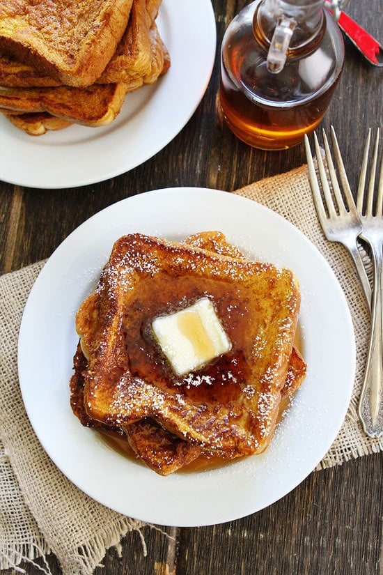 Pumpkin French Toast Recipe on twopeasandtheirpod.com Thick slices of French toast dipped in a pumpkin spice mixture! Top with butter and maple syrup for a real breakfast treat! Pumpkin French Toast Recipe
