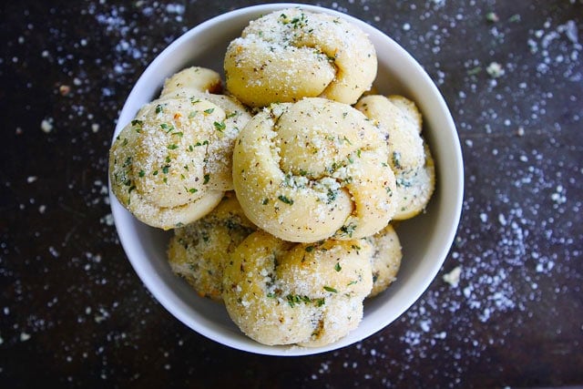 Garlic Knots Recipe on twopeasandtheirpod.com A pizzeria favorite that is easy to make at home! Bowl of homemade garlic knots