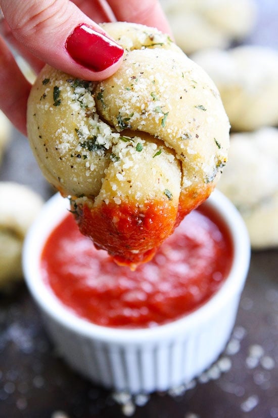 Garlic Knots Recipe on twopeasandtheirpod.com These easy and cheesy garlic knots are a pizzeria favorite but can easily be made at home! How to make garlic knots