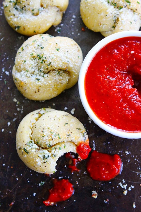 Garlic Knots Recipe on twopeasandtheirpod.com These easy and cheesy garlic knots are a fun appetizer and are the perfect start to pizza night! Easy garlic knots with marinara