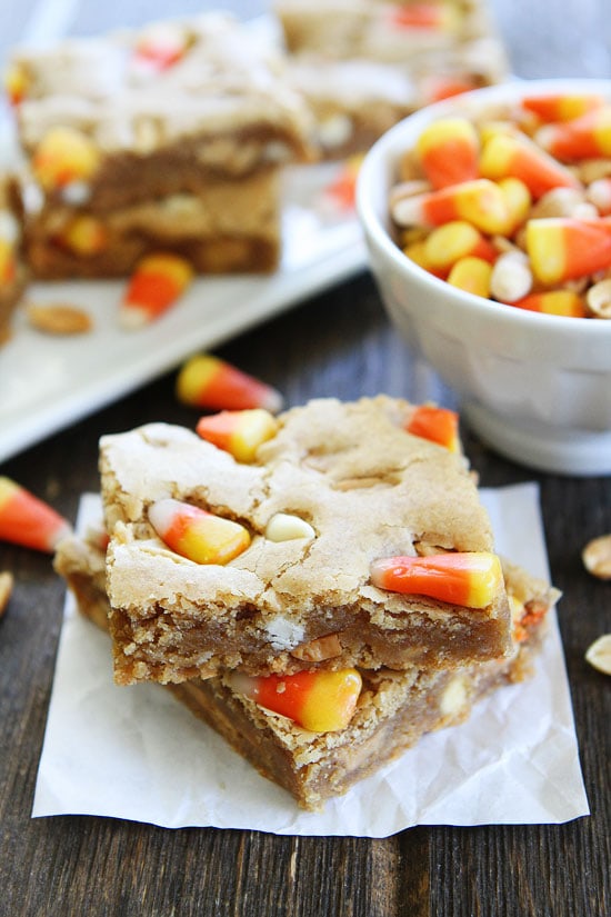 Peanut Butter Candy Corn Blondies Recipe on twopeasandtheirpod.com Peanut butter blondies with salted peanuts, white chocolate, peanut butter chips, and candy corn. The ultimate fall treat! Peanut Butter Candy Corn Blondies Recipe