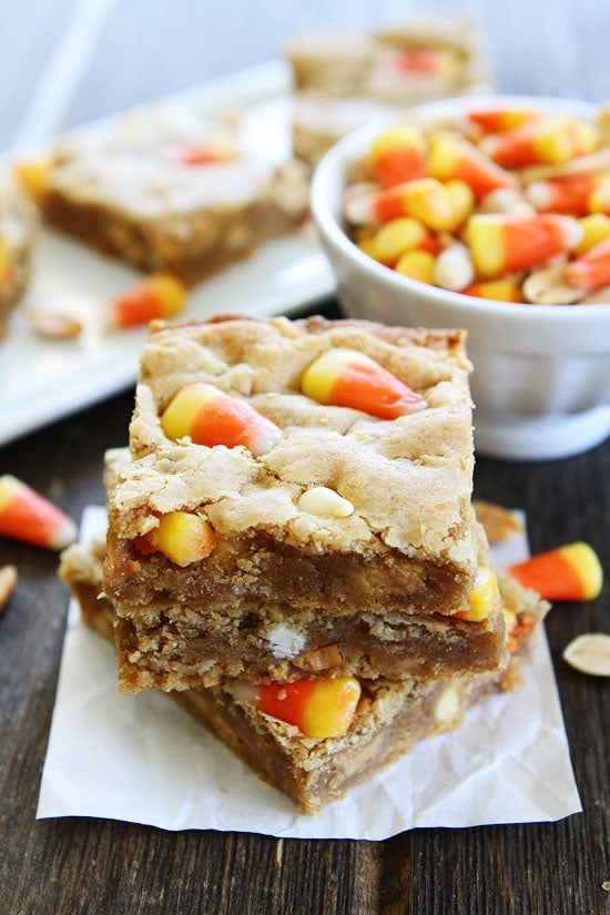 Peanut Butter Candy Corn Blondies Recipe on twopeasandtheirpod.com Peanut butter blondies with salted peanuts, white chocolate, peanut butter chips, and candy corn. These bars are the perfect treat for fall! Peanut Butter Candy Corn Blondies Recipe