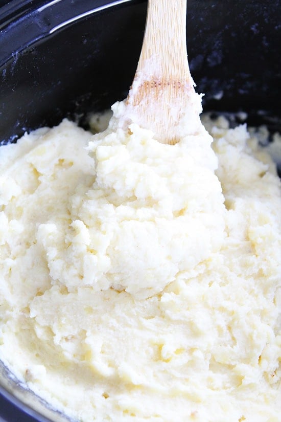 Slow Cooker Mashed Potatoes Recipe on twopeasandtheirpod.com These easy mashed potatoes are made in the crockpot and are SO good! Add them to your holiday menu right now! Slow Cooker Mashed Potatoes Recipe