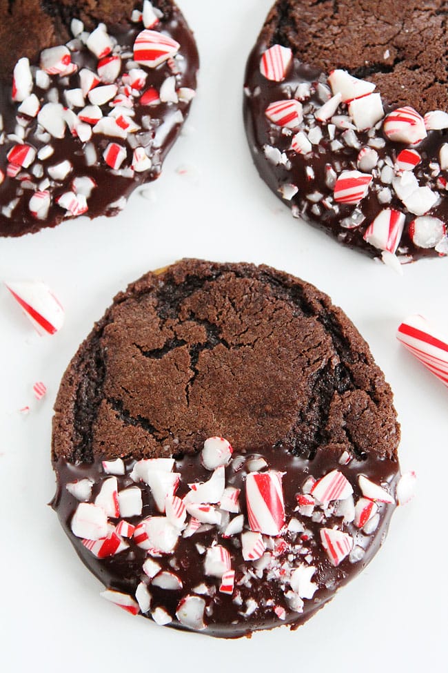 Chocolate Peppermint Ganache Cookies Recipe on twopeasandtheirpod.com Chocolate cookies dipped in ganache and sprinkled with candy cane pieces. The PERFECT holiday cookie! Chocolate Peppermint Ganache Cookies