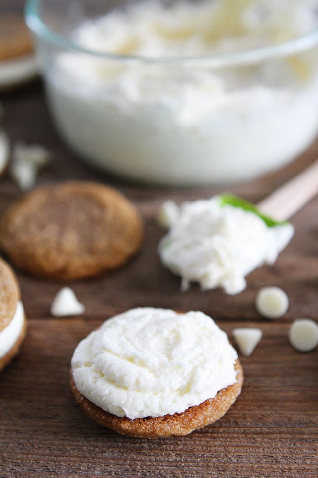 Gingersnap Sandwich Cookies with White Chocolate Filling Recipe on twopeasandtheirpod.com Soft gingersnap cookies filled with white chocolate buttercream frosting! The perfect cookies for the holidays! Gingersnap Sandwich Cookies with White Chocolate Filling Recipe