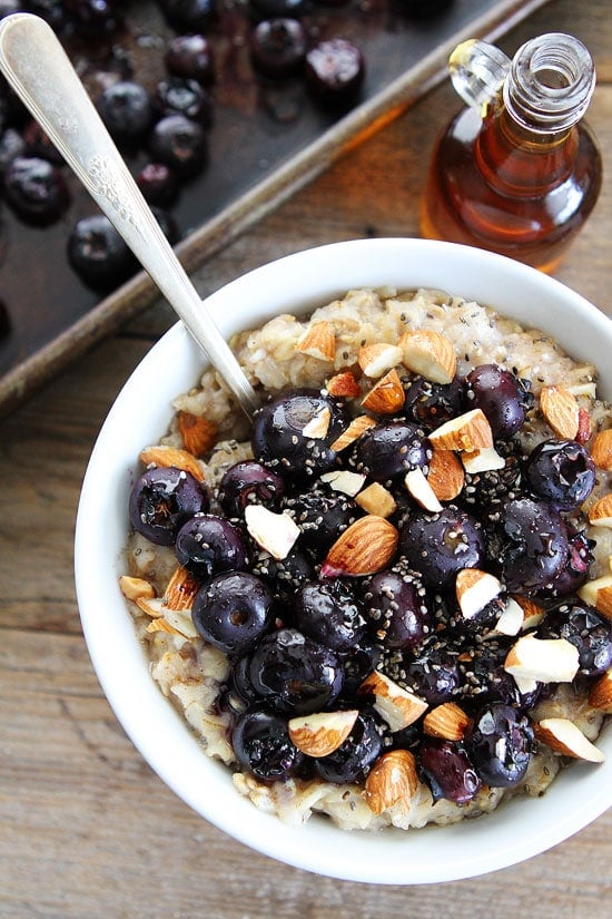 Maple Roasted Blueberry Almond Oatmeal Recipe on twopeasandtheirpod.com Hearty oatmeal topped with maple roasted blueberries, almonds, and chia seeds. This healthy bowl of oatmeal is SO good! Maple Roasted Blueberry Almond Oatmeal Recipe