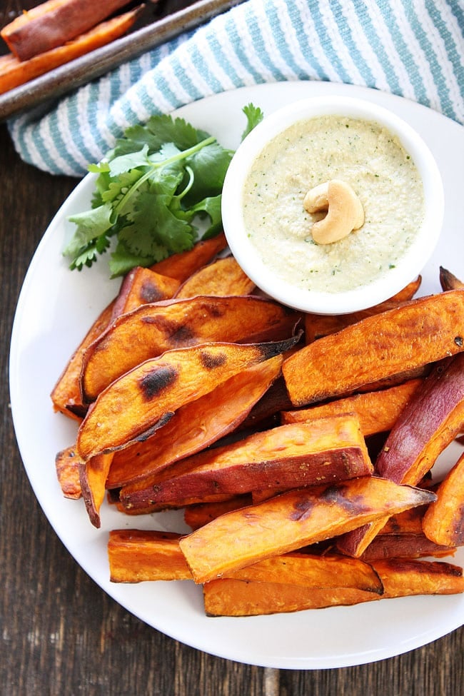 Sweet Potato Fries with Spicy Cashew Dipping Sauce Recipe on twopeasandtheirpod.com These healthy baked fries are easy to make and SO good! You will love that dipping sauce! Sweet Potato Fries with Spicy Cashew Dipping Sauce