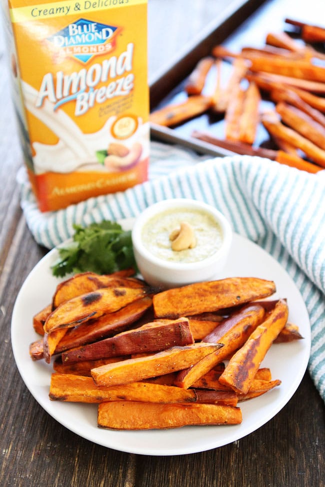 Sweet Potato Fries with Spicy Cashew Dipping Sauce Recipe on twopeasandtheirpod.com These healthy baked fries are SO good! Enjoy as an appetizer or snack! Sweet Potato Fries with Spicy Cashew Dipping Sauce Recipe