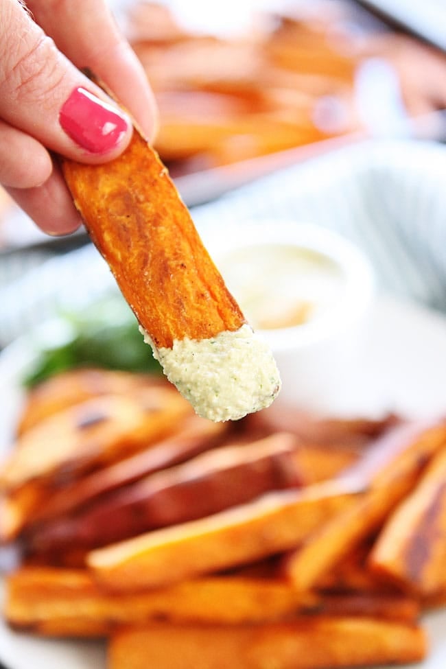 Sweet Potato Fries with Spicy Cashew Dipping Sauce Recipe on twopeasandtheirpod.com These healthy baked fries are a favorite at our house! The dipping sauce is SO good! Sweet Potato Fries with Spicy Cashew Dipping Sauce Recipe
