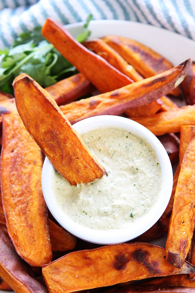 Sweet Potato Fries with Spicy Cashew Dipping Sauce Recipe on twopeasandtheirpod.com These healthy baked fries are so good dipped into the sauce! You have to try them! Sweet Potato Fries with Spicy Cashew Dipping Sauce Recipe