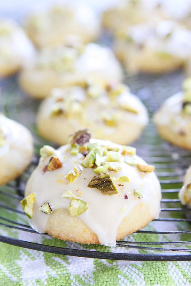 Orange Pistachio Cookie Recipe on twopeasandtheirpod.com Orange butter cookies with a sweet orange glaze and chopped pistachios. These cookies are heavenly and perfect for the holidays! Orange Pistachio Cookies