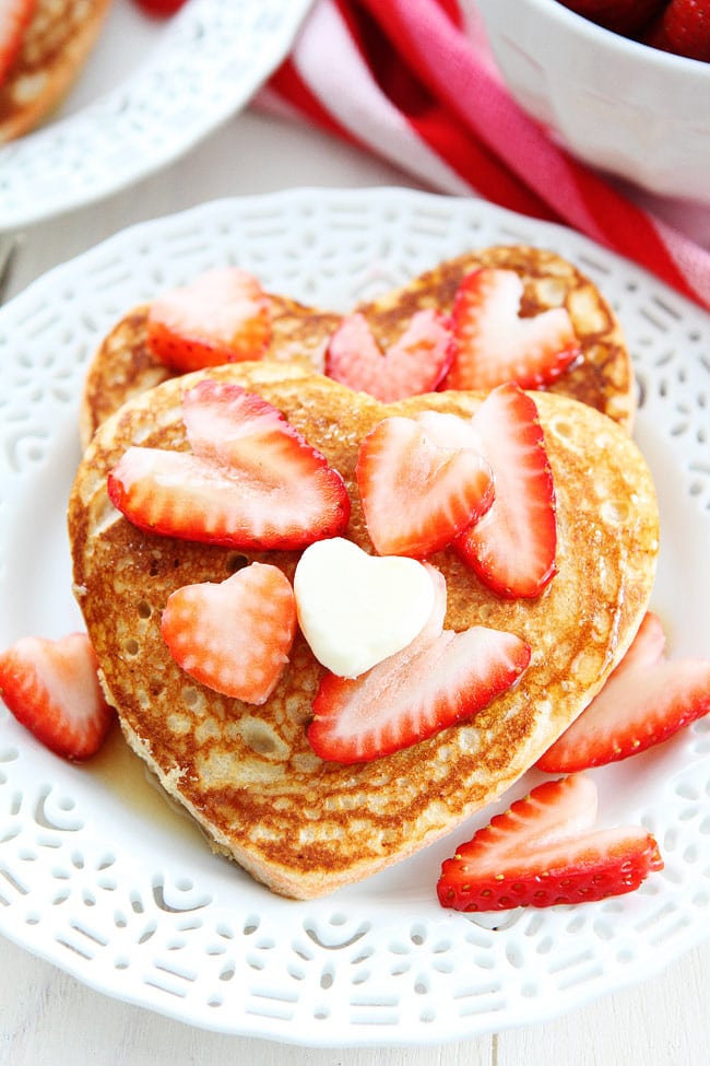 Heart Pancakes Recipe on twopeasandtheirpod.com These simple and healthy whole wheat heart shaped pancakes are perfect for Valentine's Day! Heart Pancakes Recipe
