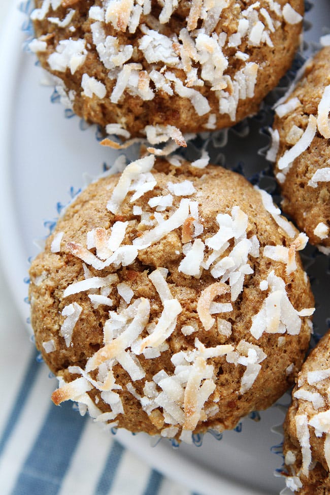 Whole Wheat Banana Coconut Muffins Recipe on twopeasandtheirpod.com These healthy muffins are made with whole wheat flour, coconut oil, coconut milk, coconut sugar, and coconut! A coconut lover's dream muffin! Whole Wheat Banana Coconut Muffins Recipe