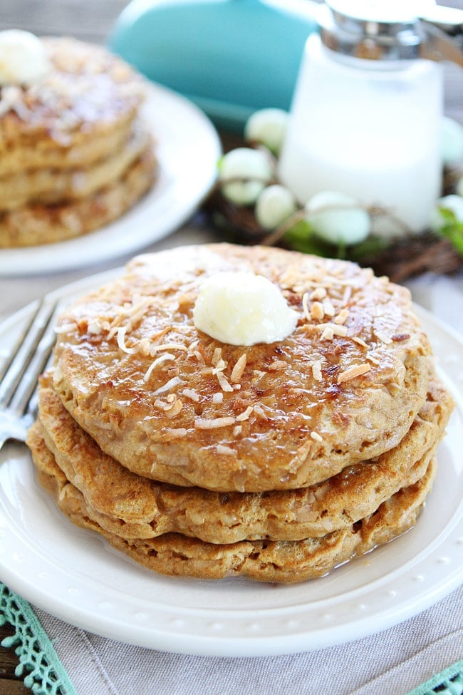 Toasted Coconut Pancakes Recipe on twopeasandtheirpod.com Light and fluffy pancakes with a sweet toasted coconut topping! These pancakes are breakfast perfection! Coconut Milk Pancakes topped with coconut pancake syrup and butter