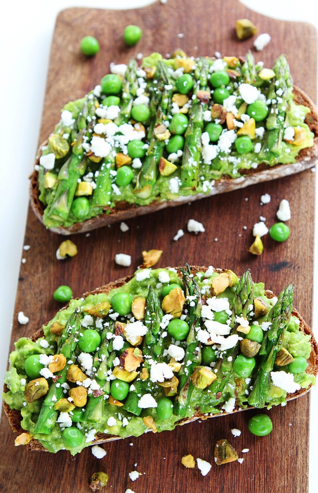 Avocado Asparagus Toast Recipe on twopeasandtheirpod.com Avocado toast with asparagus, peas, pistachios, and feta cheese. This simple spring toast makes a great appetizer, snack, or meal! Avocado Toast with Asparagus, Peas, Pistachios, and Feta Cheese
