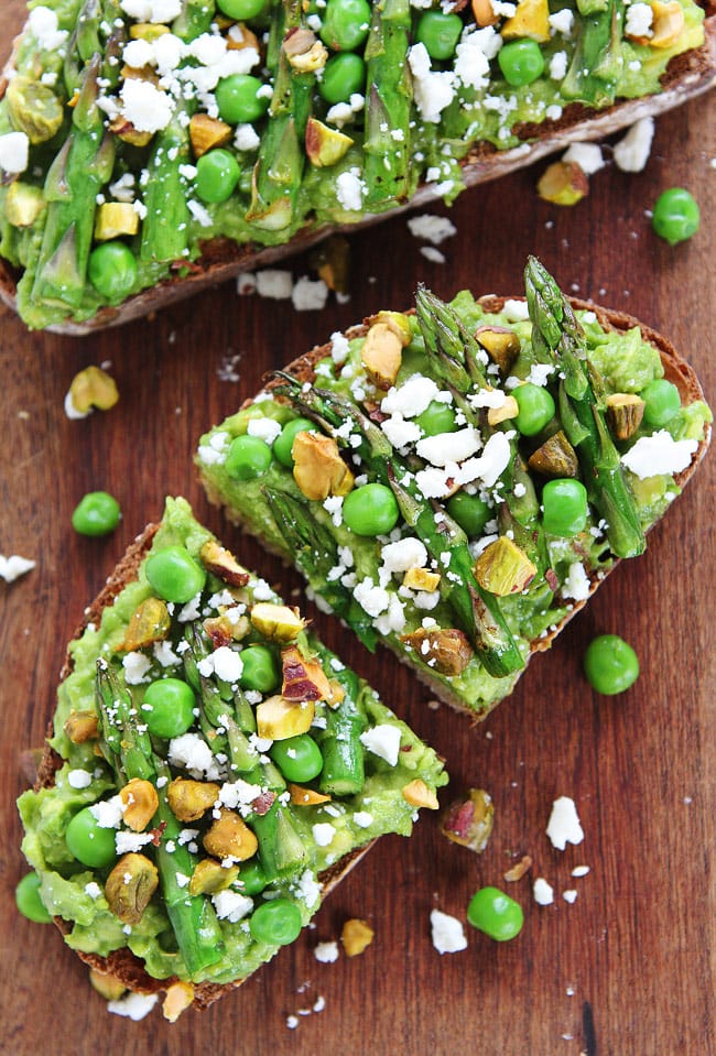 Avocado Asparagus Toast Recipe on twopeasandtheirpod.com Avocado toast with asparagus, peas, pistachios, and feta cheese. This simple spring toast is great as an appetizer, snack, or meal! Avocado Asparagus Toast Recipe