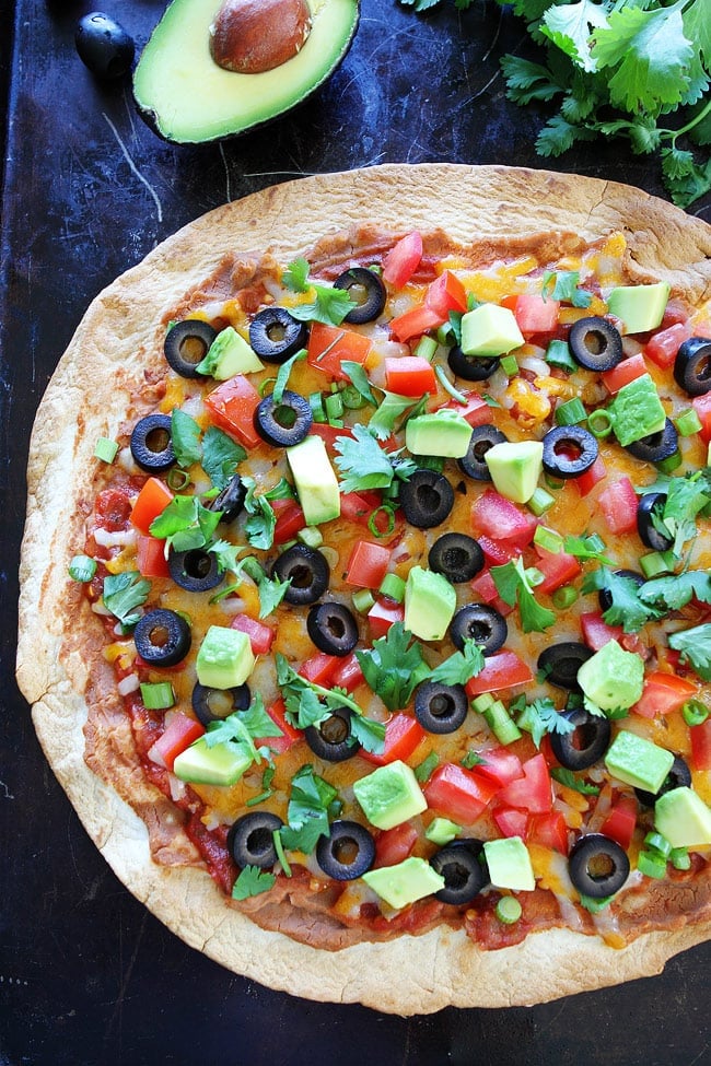 Crispy Mexican Tortilla Pizza Recipe on twopeasandtheirpod.com This easy pizza makes a great weeknight meal! Mexican Pizza with a Tortilla Crust and Topped with Fresh Vegetables