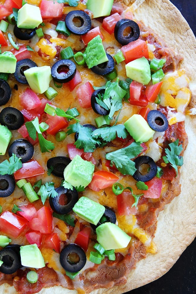 Crispy Mexican Tortilla Pizza Recipe on twopeasandtheirpod.com You can have this easy pizza on your dinner table in 15 minutes. Kids and adults love it! Close up of Mexican Pizza baked on Flour Tortilla