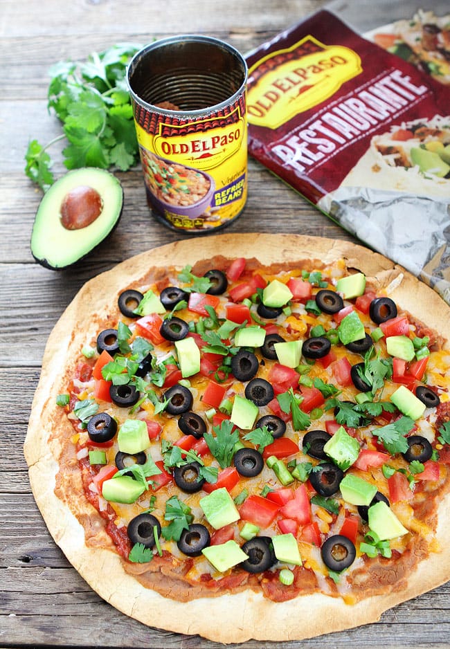 Crispy Mexican Tortilla Pizza Recipe on twopeasandtheirpod.com Kids and adults love this easy tortilla pizza! Mexican-Inspired Tortilla Pizza with Enchilada sauce and veggies