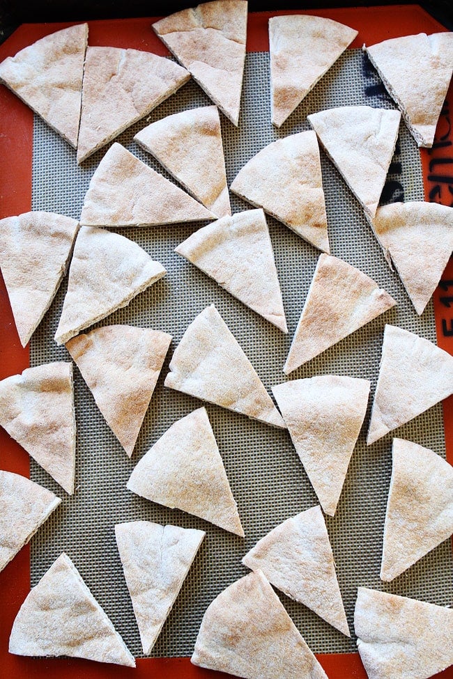 Homemade Pita Chips Recipe on twopeasandtheirpod.com Make your own pita chips at home! They are so easy and so good! pita bread cut into triangles on baking sheet with Silpat.