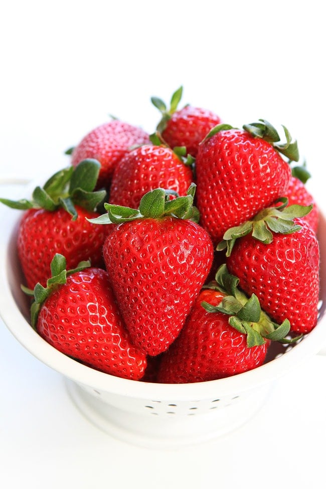 Avocado Strawberry Caprese Salad Recipe on twopeasandtheirpod.com We love this simple salad! Colander of fresh strawberries to add in caprese salad