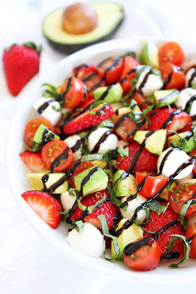 Avocado Strawberry Caprese Salad Recipe on twopeasandtheirpod.com The avocado and strawberries take this caprese salad to a whole new level! It is amazing! Caprese Salad with mozzarella, basil, tomatoes, strawberries, avocado and balsamic
