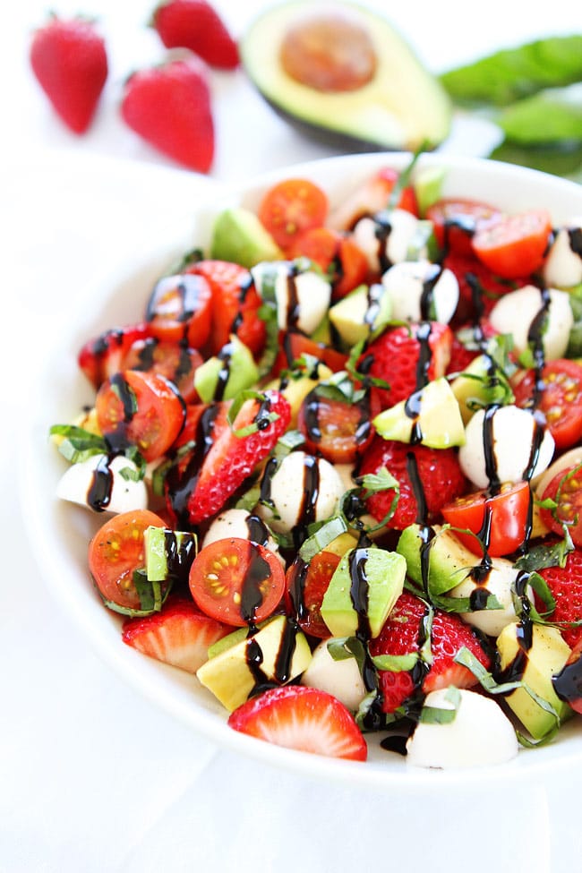 Avocado Strawberry Caprese Salad Recipe on twopeasandtheirpod.com The BEST caprese salad! The avocado and strawberries take this salad to a whole new level! Caprese Salad drizzled with balsamic oil ready to be served