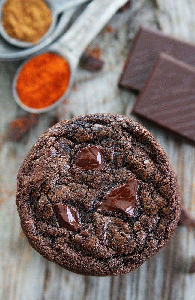 Dark Chocolate Chili Cookie Recipe on twopeasandtheirpod.com Rich chocolate cookies with a hint of cinnamon, cayenne pepper, and chili chocolate. Make sure you have a glass of milk nearby because these cookies have a kick! Dark Chocolate Chili Cookies