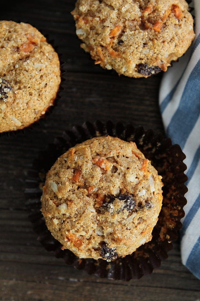 Morning Glory Muffin Recipe on twopeasandtheirpod.com These healthy whole wheat muffins are packed with pineapple, carrots, coconut, and raisins. Removing muffin wrapper from Morning Glory Muffins