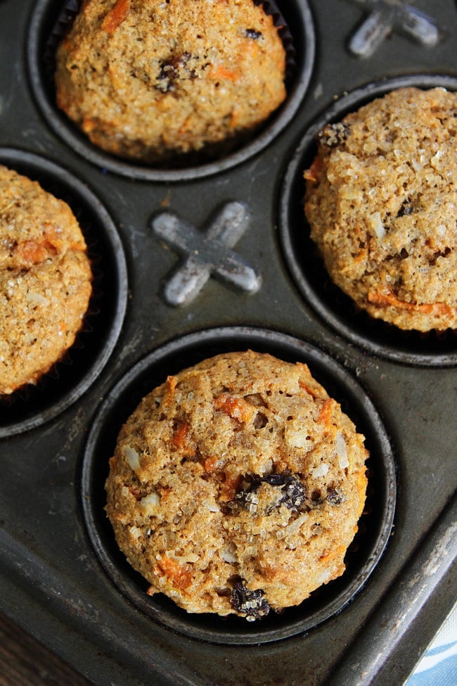 Morning Glory Muffin Recipe on twopeasandtheirpod.com Whole wheat muffins packed with pineapple, carrots, coconut, and raisins. We love these healthy muffins! hot Morning Glory Muffins in baking tins