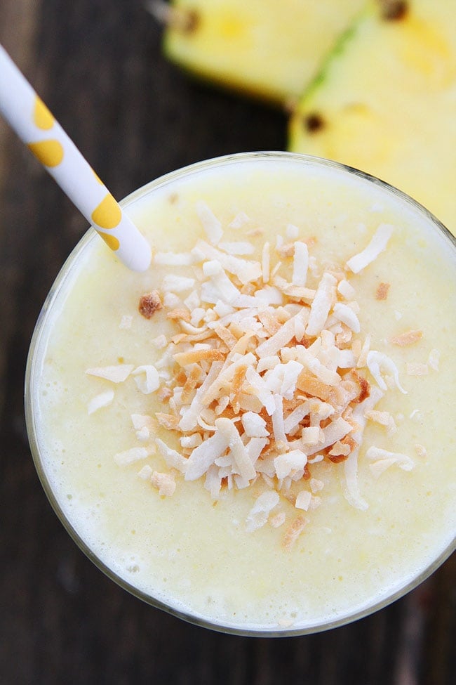 Pineapple Coconut Smoothie Recipe on twopeasandtheirpod.com This simple and healthy smoothie is great for breakfast or a snack! Pineapple Coconut Smoothie in a glass with a straw