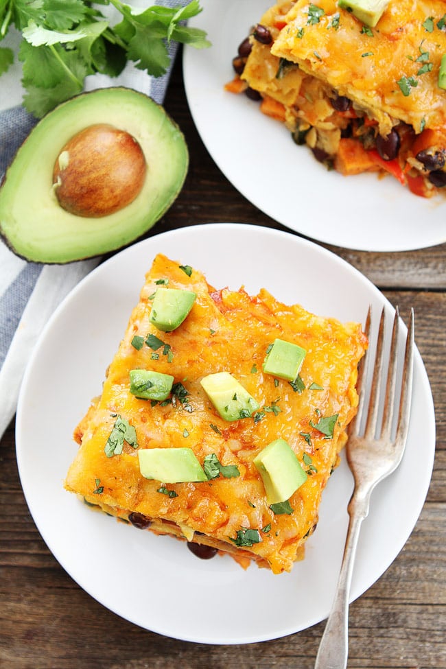 Stacked Sweet Potato and Black Bean Enchiladas Recipe on twopeasandtheirpod.com This easy enchilada casserole is gluten-free, vegetarian, and loaded with flavor. It is one of our favorite meals! Stacked Sweet Potato and Black Bean Enchiladas Recipe